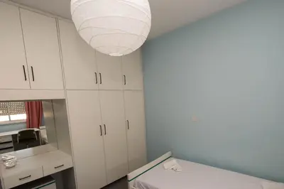 a room with white cabinets and a light fixture at private room in a shared flat at best location in Limassol
