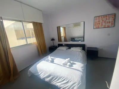 a bedroom with a bed with two teddy bears on it at private room in a shared flat at best location in Limassol