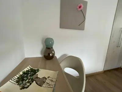 a table with a book and a vase on it at Lovely 1-bd apt with patio in Nicosia center in Nicosia