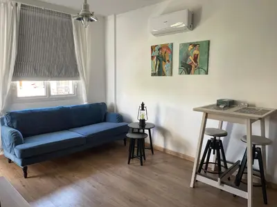 a living room with a blue couch and a table at Lovely 1-bd apt with patio in Nicosia center in Nicosia