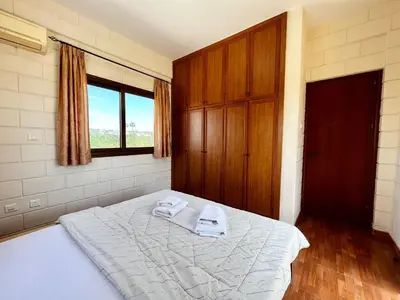 a bedroom with a bed with two towels on it at STAY Pernera House in Ayia Napa