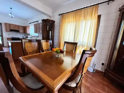 a dining room table with a bowl of fruit on it at STAY Pernera House in Ayia Napa