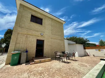 a building with chairs and a table in front of it at STAY Pernera House in Ayia Napa