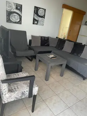 a living room with a couch and a table and chairs at Protaras, Janas apartment in Protaras