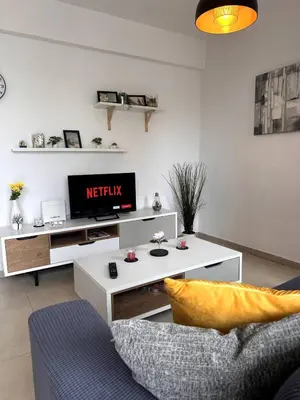a living room with a tv and a couch at Olymbos Garden Apartment IV in Ayia Napa