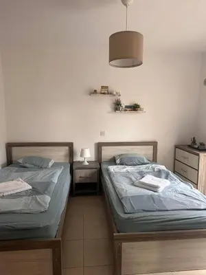 two beds sitting next to each other in a bedroom at Olymbos Garden Apartment IV in Ayia Napa