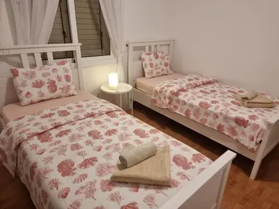 a bedroom with two beds and a candle in it at Protaras sea view Villa with private pool in Protaras