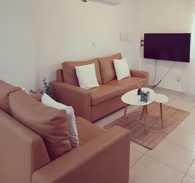 a living room with a couch and a table at Protaras sea view Villa with private pool in Protaras