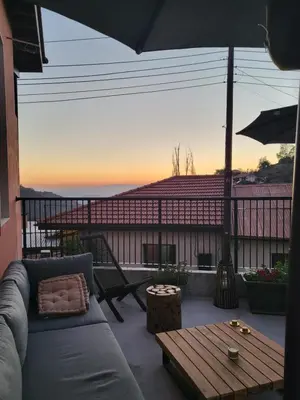 a patio with a couch and a table on a balcony at Selin the stone house in Limassol