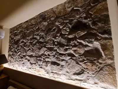 a stone wall in a hotel room with a rock wall at Selin the stone house in Limassol