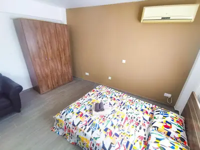 a bedroom with a bed with a colorful comforter at Hidden Gem City Studio in Larnaka