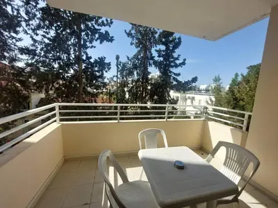 a white table and chairs on a balcony at Sunny 2 Bedroom Larnaca Center in Larnaka