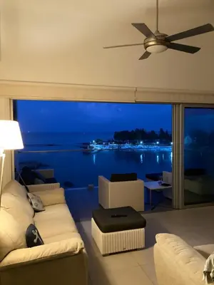 a living room with a couch and a ceiling fan at Trident Beach Apartment in Protaras
