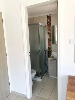 a bathroom with a shower and a toilet and a sink at Villa Alba, Luxury 4 BDRM Villa with Heated Pool in Protaras