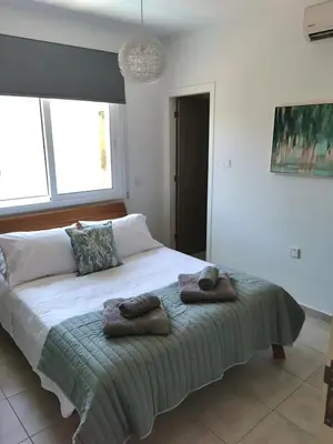 a bedroom with a bed with two towels on it at Villa Alba, Luxury 4 BDRM Villa with Heated Pool in Protaras