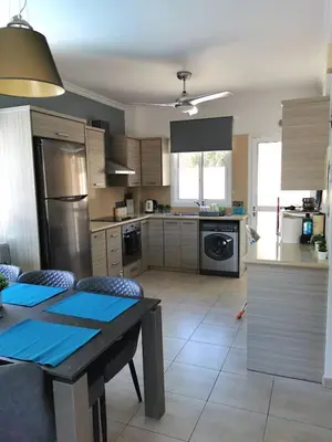 a kitchen with a table and a kitchen with a stove at Villa Alba, Luxury 4 BDRM Villa with Heated Pool in Protaras