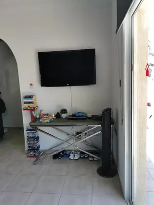 a room with a table and a television on a wall at Villa Alba, Luxury 4 BDRM Villa with Heated Pool in Protaras