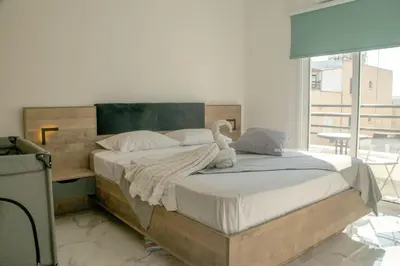 a bedroom with a large bed with a swan on it at Mad beach in Protaras
