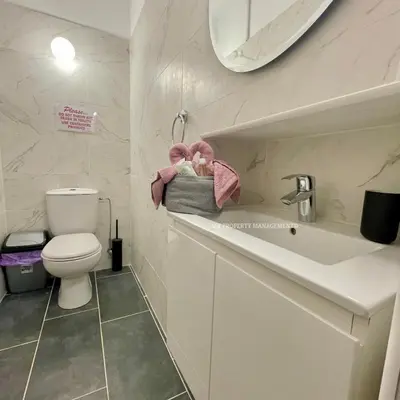 a bathroom with a toilet and a sink and a mirror at Mad beach in Protaras