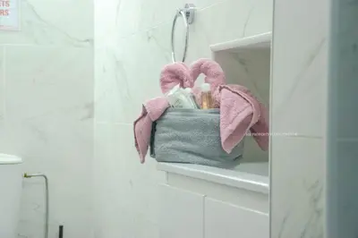 a bathroom shelf with a basket of bathroom items at Mad beach in Protaras