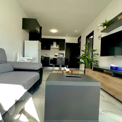 a living room with a couch and a table at Mad beach in Protaras