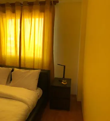 a bedroom with a bed and a lamp on a night stand at StayCity Flat!!! in Nicosia