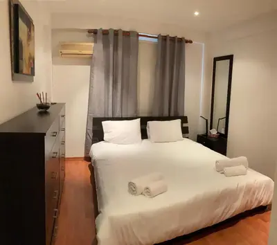 a bedroom with a bed with two towels on it at StayCity Flat!!! in Nicosia