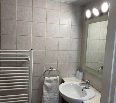 a bathroom with a sink and a mirror at StayCity Flat!!! in Nicosia