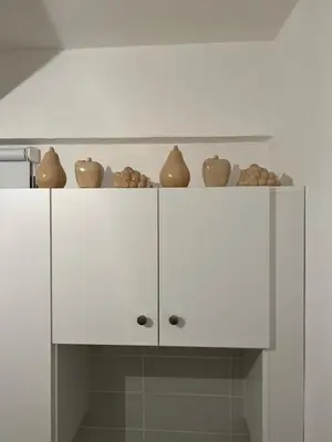 a kitchen with white cabinets with vases on them at ARTEMIS 1 Bdr Down Town Nicosia in Nicosia