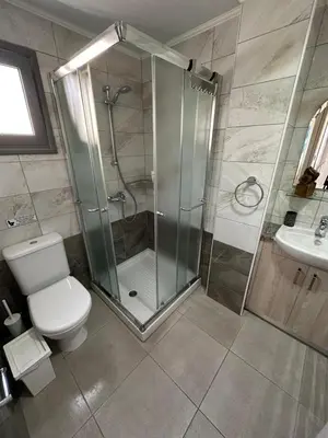 a bathroom with a shower and a toilet and a sink at Modern City Center Apartment Saripolou 2 in Limassol