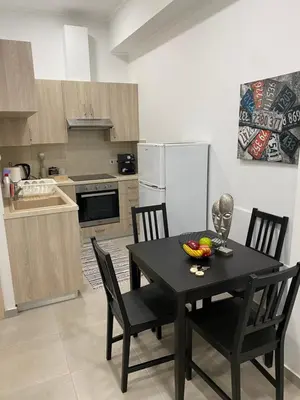 a kitchen with a black table and chairs in a kitchen at Modern City Center Apartment Saripolou 2 in Limassol
