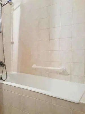 a white bath tub in a bathroom with a shower at Armstrong Apartment in Paralimni