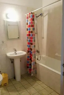 a bathroom with a sink and a shower curtain at Armstrong Apartment in Paralimni