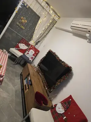 a living room with christmas decorations on the wall at Pampering Beach Dream, A Stunning Luxury Retreat at Yialos Village in Meneou