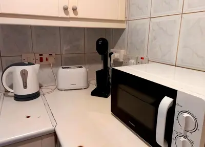 a kitchen with a counter top with a microwave at Ariadne 1, Sea Side Boutique Apartment in Limassol