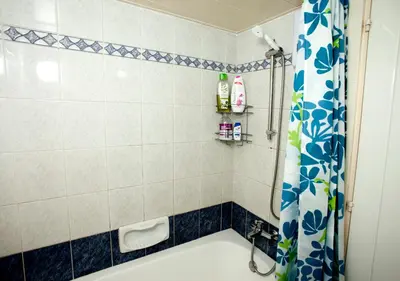 a bathroom with a tub and a shower curtain at Ariadne 1, Sea Side Boutique Apartment in Limassol