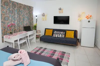 a living room with a couch and a table at Ariadne 1, Sea Side Boutique Apartment in Limassol
