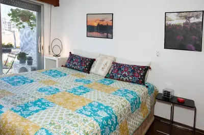 a bedroom with a bed with a quilt on it at ARTEMIS 3, Beachfront Boutique Apartment in Limassol