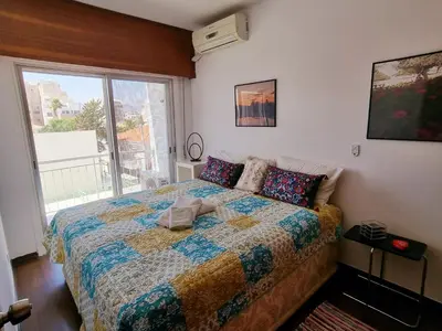 a bedroom with a bed and a large window at ARTEMIS 3, Beachfront Boutique Apartment in Limassol