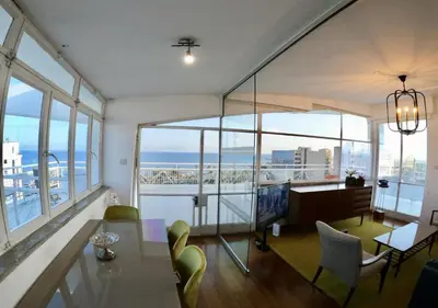 a living room with a view of the ocean at 1-80 Collection Penthouse by TrulyCyprus in Limassol