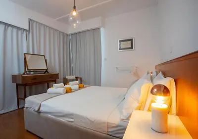 a bedroom with a bed with a desk and a mirror at 1-80 Collection Penthouse by TrulyCyprus in Limassol