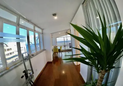a hallway with a plant in a room with windows at 1-80 Collection Penthouse by TrulyCyprus in Limassol