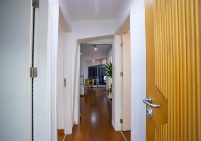 a hallway with a yellow door and a hallway with a hallwayngthngthngthngth at 1-80 Collection Penthouse by TrulyCyprus in Limassol