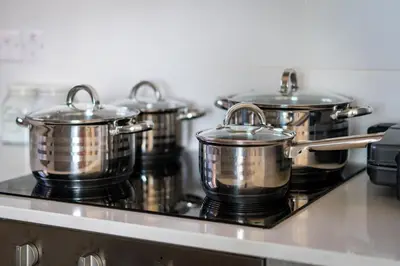 a group of pots and pans on a stove at Majestic Sunset Salt Lake Views 300m from beach in Larnaka