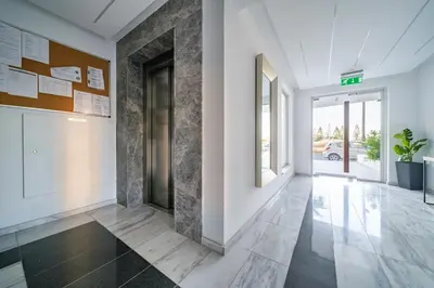 a hallway of a building with a door and a hallway sidx sidx sidx at Majestic Sunset Salt Lake Views 300m from beach in Larnaka