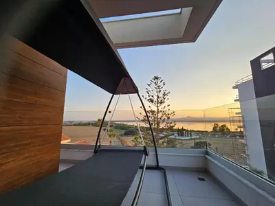 a room with a balcony with a view of the ocean at Majestic Sunset Salt Lake Views 300m from beach in Larnaka