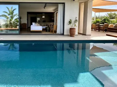 a swimming pool in front of a house with a bedroom at Lora Pearl Luxury Villa in Protaras