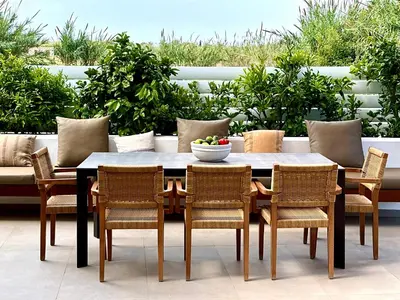 a dining table with chairs and a bowl of fruit on it at Lora Pearl Luxury Villa in Protaras