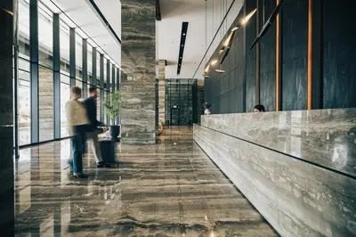 a lobby of a building with two people walking down a hallway at The Icon Limassol in Limassol