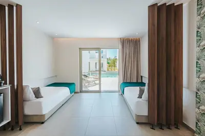 a hotel room with two beds and a pool at Atlantica Sungarden Park in Ayia Napa